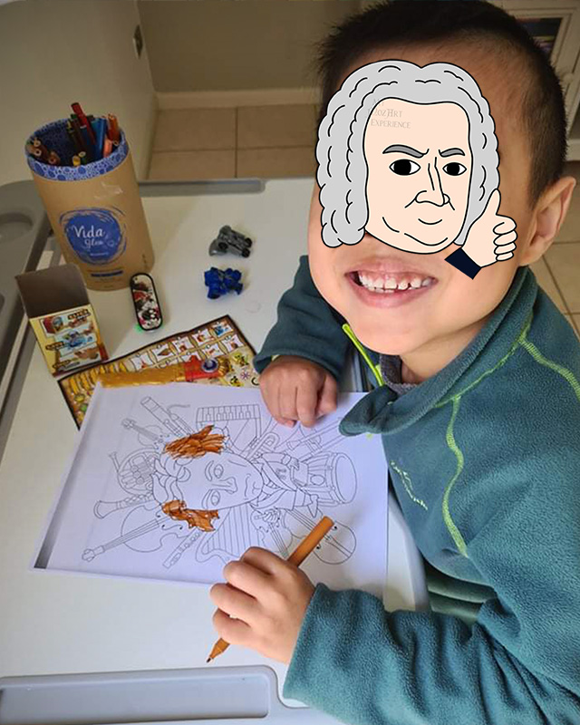 Young child smiles as he colours in his classical music colouring book